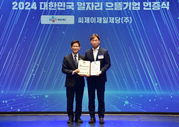 ▲CJ제일제당 노사협력담당 김치홍 상무(오른쪽)와 고용노동부 김문수 장관이 일자리 으뜸기업 인증식에서 기념 촬영을 하고있다