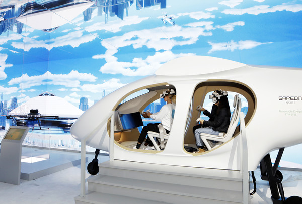 ▲ ‘CES 2023’의 SK그룹관을 사전 방문한 관람객들이 SK텔레콤의 도심항공교통(UAM) 모형에 탑승해 운행 체험을 하고 있다.