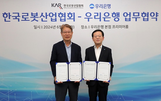 ▲ 지난 4일 열린 업무협약식에서 조병규 우리은행장(오른쪽)과 김진오 한국로봇산업협회장이 기념촬영을 하고 있다.