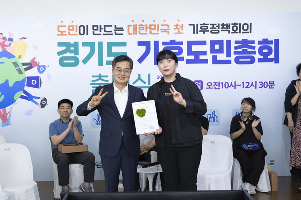 ▲30일 오전 시흥 에코센터에서 열린 경기도 기후도민총회 출범식에서 김동연 경기도지사(왼쪽)가 위촉장 수여 후 기념촬영을 하고 있다.